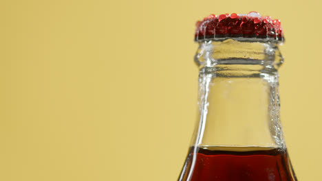 Close-Up-Of-Condensation-Droplets-On-Neck-Of-Revolving-Bottle-Of-Cold-Beer-Or-Soft-Drink-With-Metal-Cap